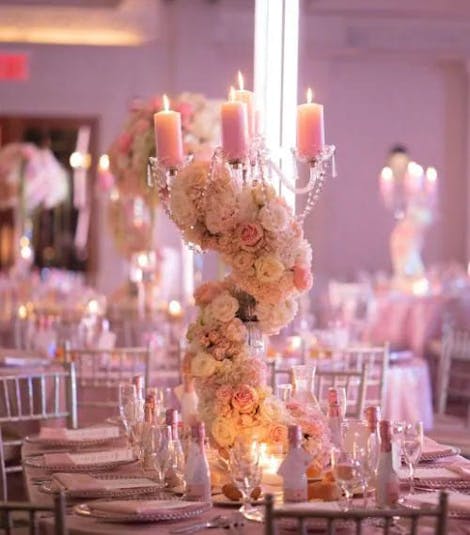 The same bouquet has been replicated and placed on several place settings at a wedding reception